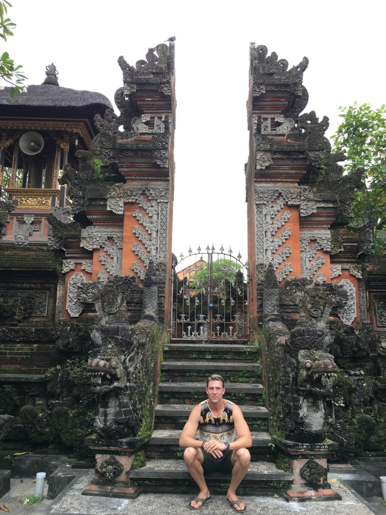 Sitting on the steps of a Balinese temple gate